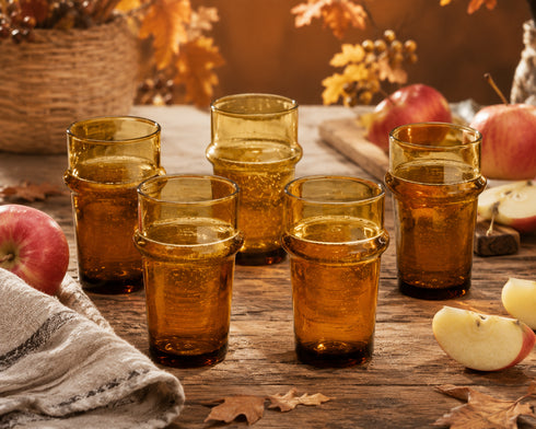 Warm up your drinkware collection with an Art of handmade amber Moroccan tea glass.