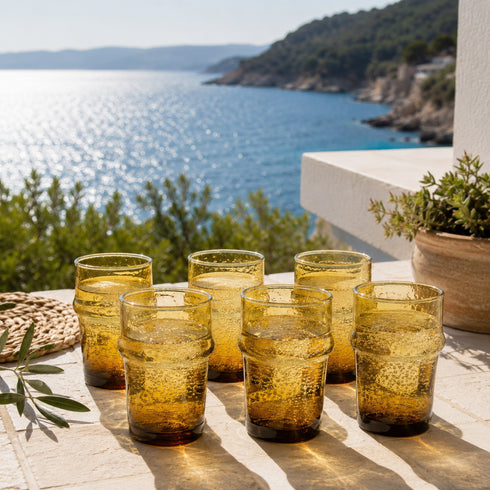 Warm up your drinkware collection with an Art of handmade amber Moroccan tea glass.