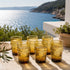 Warm up your drinkware collection with an Art of handmade amber Moroccan tea glass.