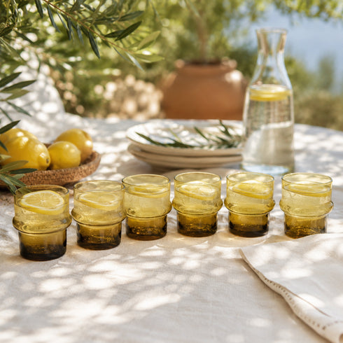 Warm up your drinkware collection with an Art of handmade amber Moroccan tea glass.