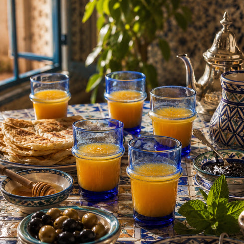 Dress a vibrant tablescape with our Art of handmade blue Moroccan Beldi glasses.