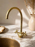 Complete your custom vanity with an Art of handmade brass arched faucet.