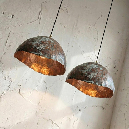 Add artistic elegance to your space with an Art of handmade copper teardrop light.