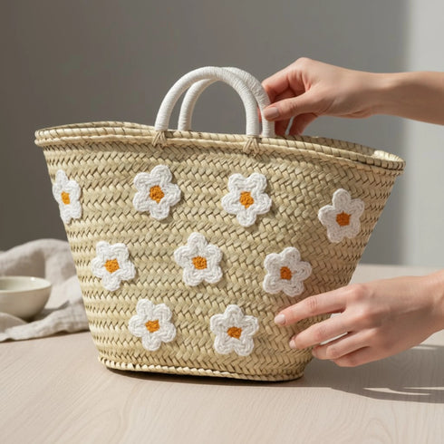 Handwoven Moroccan straw basket with white embroidered flowers