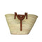 Handwoven Moroccan straw basket with brown leather handles and front closure
