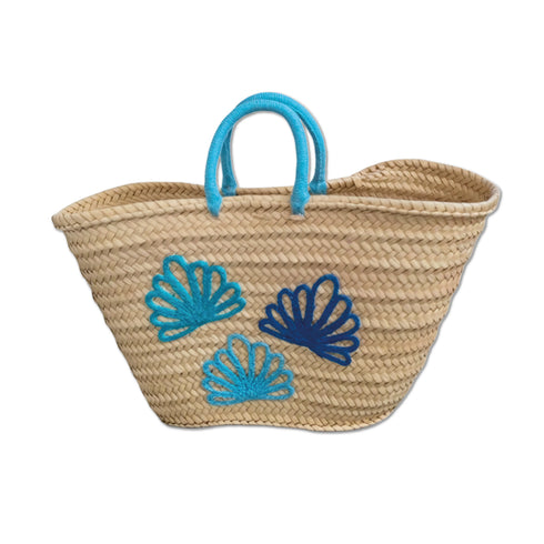 Handwoven Moroccan straw tote bag with blue shell embroidery and turquoise braided handles