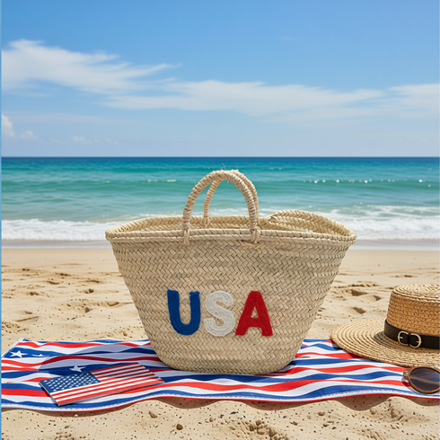Handwoven straw tote bag with USA embroidered lettering in red, white, and blue
