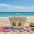 Handwoven straw tote bag with USA embroidered lettering in red, white, and blue