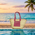 Handwoven straw tote bag with pink leather handles and front zip pocket