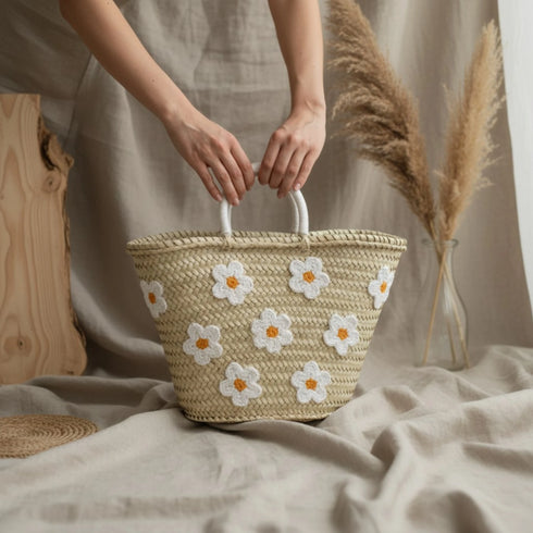 Large handwoven Moroccan straw basket with white embroidered flowers