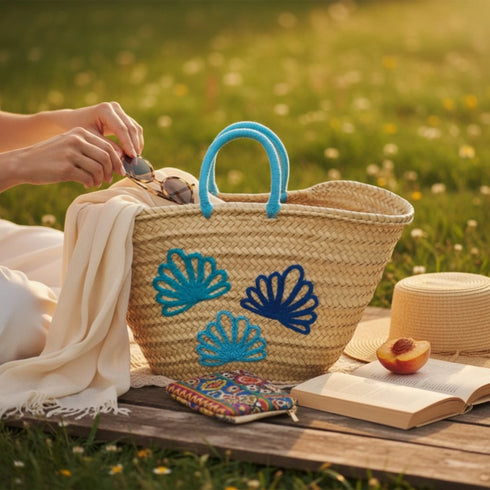 Handwoven Moroccan straw basket with embroidered shell motif