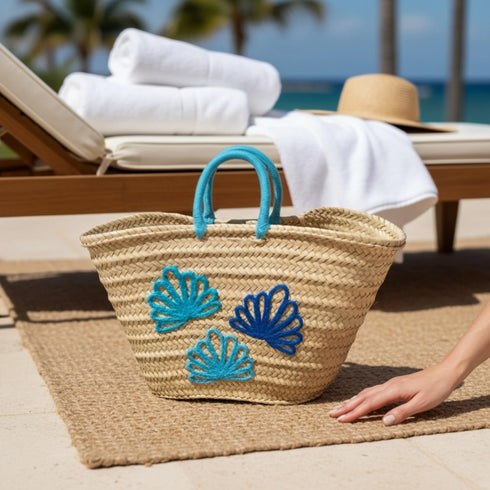 Handwoven Moroccan straw basket with embroidered shell motif