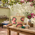 Handwoven Moroccan Palm Leaf Basket with Pink & Green Embroidery