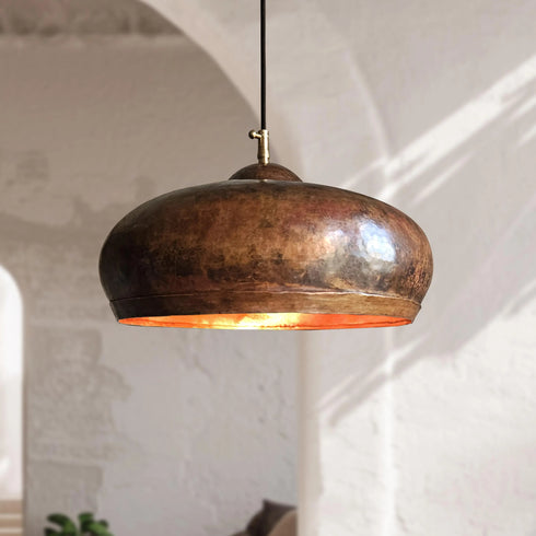 Illuminate your kitchen island with this rustic Art of handmade copper dome pendant.